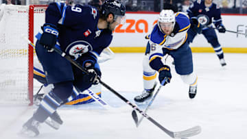 Apr 19, 2025; Winnipeg, Manitoba, CAN; St. Louis Blues defenseman Philip Broberg (6) skates into Winnipeg Jets forward Alex Iafallo (9) during the second period in game one of the first round of the 2025 Stanley Cup Playoffs at Canada Life Centre. Mandatory Credit: Terrence Lee-Imagn Images