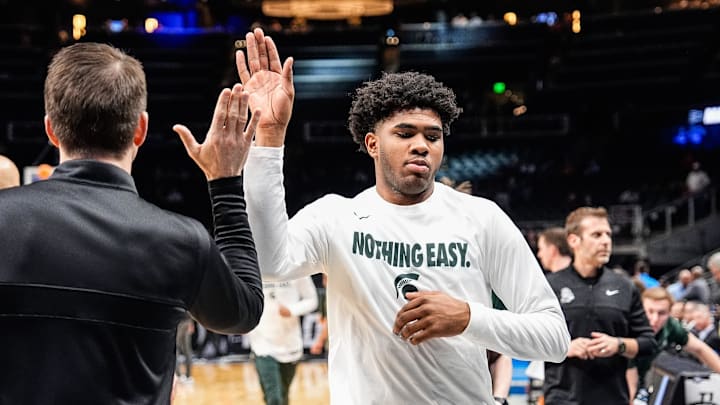 Michigan State guard Jase Richardson (11) high-fives assistant coach Jon Borovich as he runs off the court after warm up ahead of the Sweet 16 round of NCAA tournament against Ole Miss at State Farm Arena in Atlanta, Ga. on Friday, March 28, 2025.