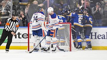 St. Louis Blues center Jordan Kyrou (25) celebrates with teammates after scoring against Edmonton Oilers goaltender Stuart Skinner (74)