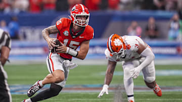 Aug 31, 2024; Atlanta, Georgia, USA; Georgia Bulldogs quarterback Carson Beck (15) runs past Clemson Tigers defensive end T.J. Parker (3) during the second half at Mercedes-Benz Stadium. Mandatory Credit: Dale Zanine-USA TODAY Sports