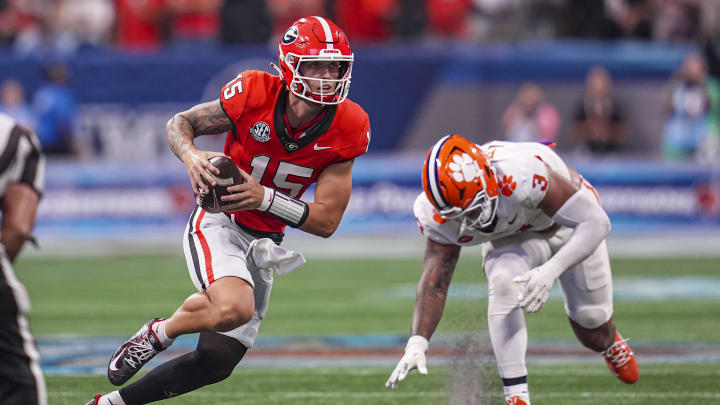 Aug 31, 2024; Atlanta, Georgia, USA; Georgia Bulldogs quarterback Carson Beck (15) runs past Clemson Tigers defensive end T.J. Parker (3) during the second half at Mercedes-Benz Stadium. Mandatory Credit: Dale Zanine-USA TODAY Sports