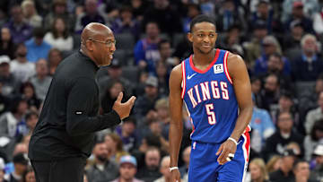 Nov 16, 2024; Sacramento, California, USA; Sacramento Kings head coach Mike Brown (left) talks with guard De'Aaron Fox (5) during the second quarter against the Utah Jazz at Golden 1 Center. Mandatory Credit: Darren Yamashita-Imagn Images