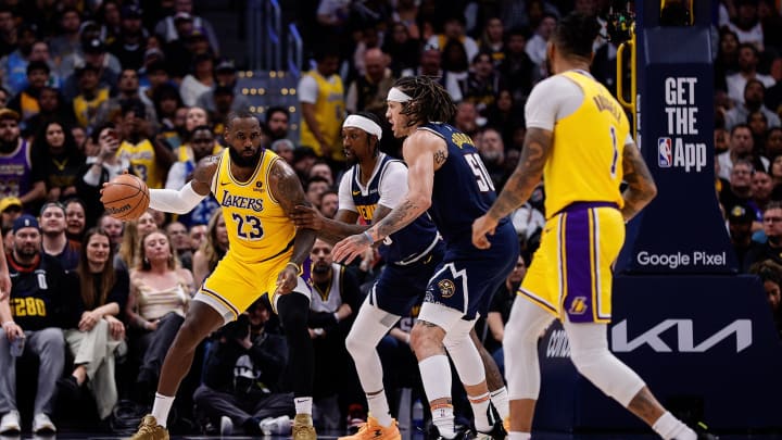 Apr 29, 2024; Denver, Colorado, USA; Los Angeles Lakers forward LeBron James (23) looks to pass to guard D'Angelo Russell (1) as Denver Nuggets guard Kentavious Caldwell-Pope (5) and forward Aaron Gordon (50) defend in the third quarter during game five of the first round for the 2024 NBA playoffs at Ball Arena. Mandatory Credit: Isaiah J. Downing-USA TODAY Sports