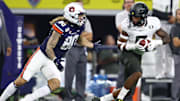 Aug 31, 2019; Arlington, TX, USA; Oregon Ducks safety Jevon Holland (8) intercepts the ball in the second quarter against Auburn Tigers receiver Sal Cannella (80) at AT&T Stadium. Mandatory Credit: Matthew Emmons-Imagn Images