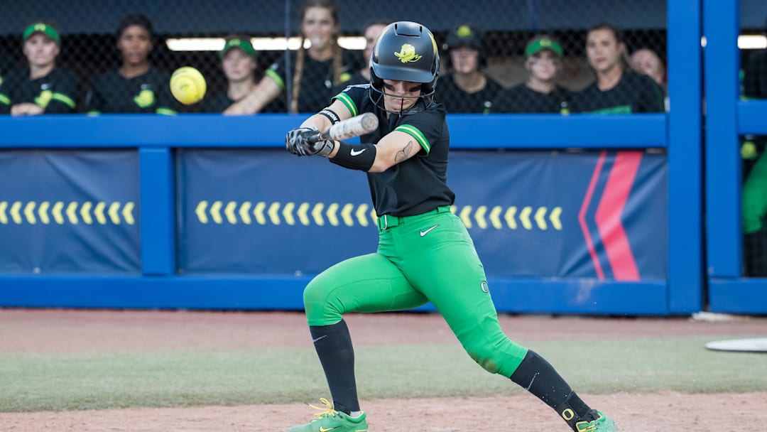 Jun 1, 2025; Oklahoma City, OK, USA;  Oregon Ducks infielder Kaylynn Jones (3) slaps the ball for a single in the fourth inning against the Oklahoma Sooners during the NCAA Softball Women's College World Series at Devon Park. Mandatory Credit: Brett Rojo-Imagn Images