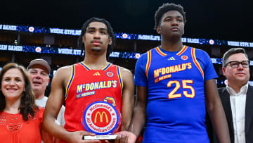 McDonald's All American West guard Dylan Harper (2) and McDonald's All American East center Derik Queen (25) are presented with the MVP trophy after the game at Toyota Center. 
