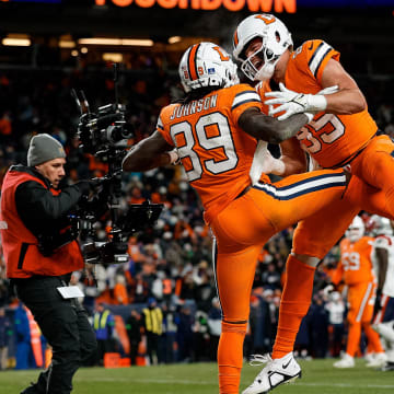 Dec 24, 2023; Denver, Colorado, USA; Denver Broncos wide receiver Brandon Johnson (89) celebrates his touchdown with tight end Lucas Krull (85) in the fourth quarter against the New England Patriots at Empower Field at Mile High. Mandatory Credit: Isaiah J. Downing-USA TODAY Sports
