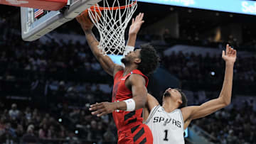 Dec 21, 2024; San Antonio, Texas, USA;  Portland Trail Blazers guard Scoot Henderson (00) shoots the ball against San Antonio Spurs center Victor Wembanyama (1) in the first half at Frost Bank Center. Mandatory Credit: Daniel Dunn-Imagn Images