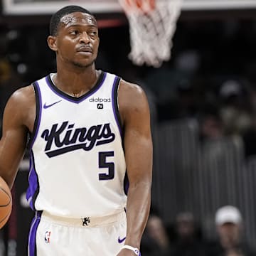 Dec 29, 2023; Atlanta, Georgia, USA; Sacramento Kings guard De'Aaron Fox (5) reacts as he controls the ball against the Atlanta Hawks during the first half at State Farm Arena. Mandatory Credit: Dale Zanine-Imagn Images