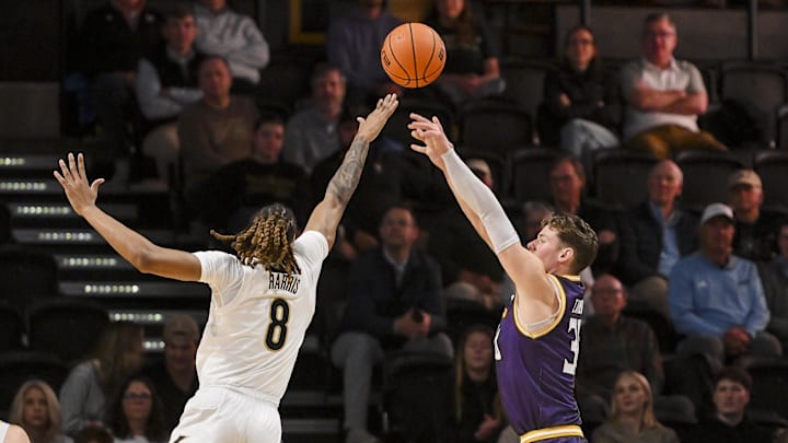 Nov 3, 2025; Nashville, Tennessee, USA;  Vanderbilt Commodores guard Tyler Harris (8) blocks the shot of  Lipscomb Bisons guard Ross Candelino (30) during the first half at Memorial Gymnasium. Mandatory Credit: Steve Roberts-Imagn Images
