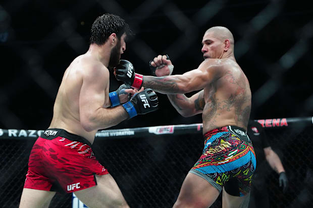 Alex Pereira (red gloves) fights Magomed Ankalaev (blue gloves) during UFC 313 at T-Mobile Arena. 