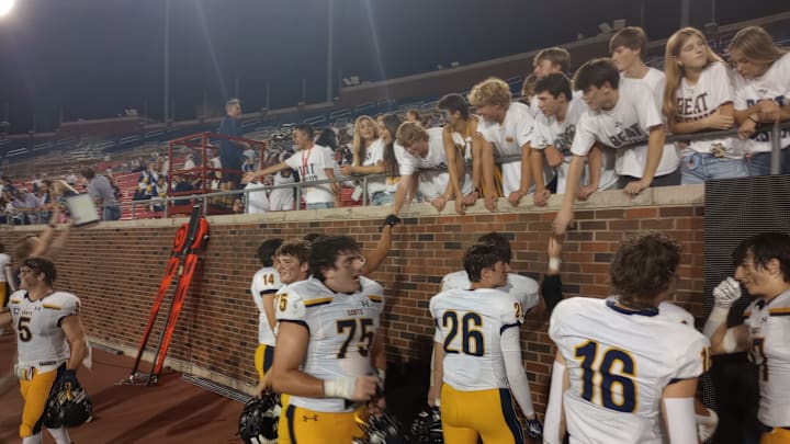 Highland Park players celebrate with fellow students after the Scots' 43-20 win against Dallas Jesuit on Sept. 13, 2024.