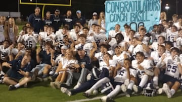 Flower Mound players pose for a postgame photo after the Jaguars' win at Lake Highlands on Sept. 12, 2024. It was also the 100th career win for coach Brian Basil.