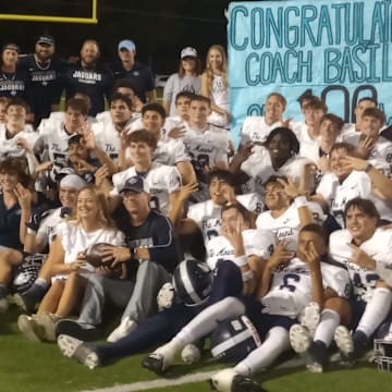 Flower Mound players pose for a postgame photo after the Jaguars' win at Lake Highlands on Sept. 12, 2024. It was also the 100th career win for coach Brian Basil.