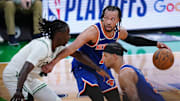 Brunson moves the ball against Holiday in overtime of Game 1 of the Eastern Conference semifinals.