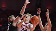 Feb 15, 2025; Champaign, Illinois, USA;  Illinois Fighting Illini guard Kasparas Jakucionis (32) drives to the basket against Michigan State Spartans forward Jaxon Kohler (0) and Szymon Zapala (10) during the first half at State Farm Center. Mandatory Credit: Ron Johnson-Imagn Images