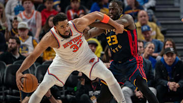 Mar 15, 2025; San Francisco, California, USA; New York Knicks center Karl-Anthony Towns (32) controls the basketball against Golden State Warriors forward Draymond Green (23) during the third quarter at Chase Center. Mandatory Credit: Neville E. Guard-Imagn Images