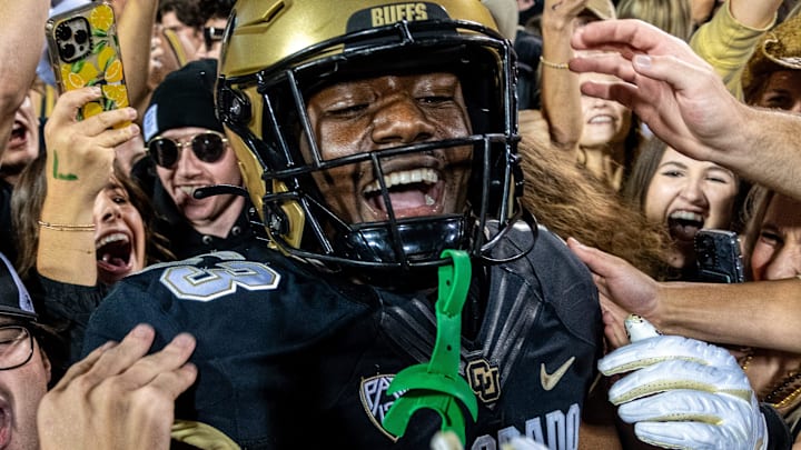 CU football sophomore defensive end Arden Walker celebrates with students who rushed the field after a thrilling win against CSU in the Rocky Mountain Showdown on Sept. 16, 2023 at Folsom Field in Boulder, Colo.
