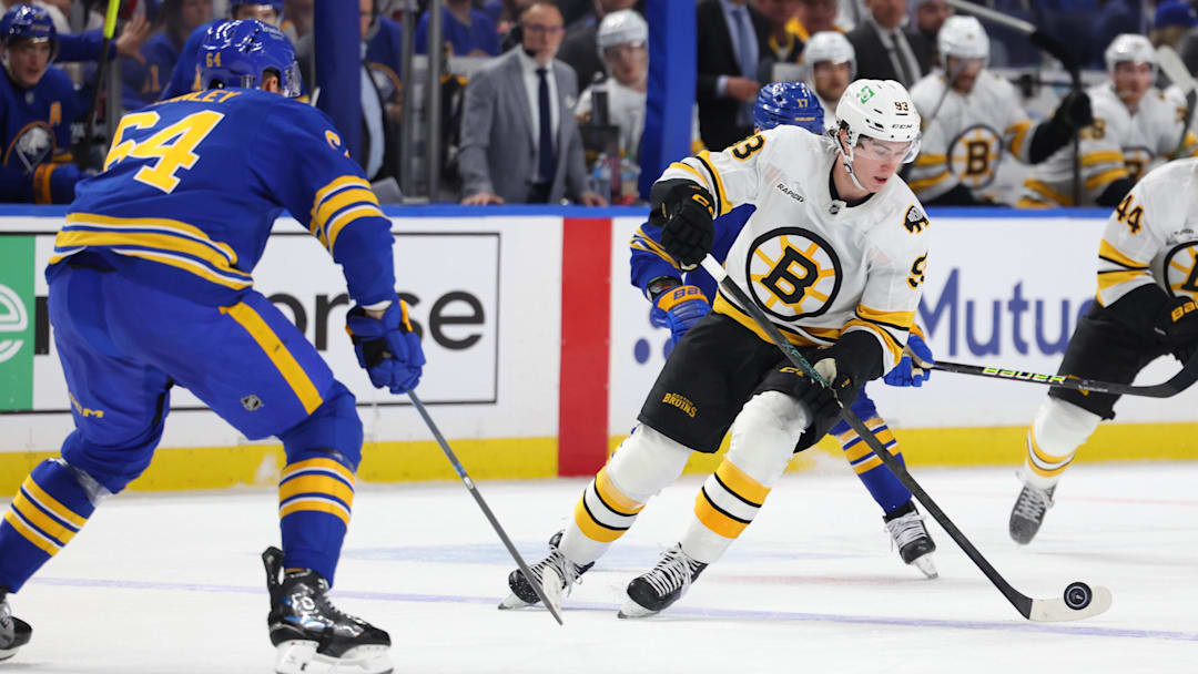 Apr 21, 2026; Buffalo, New York, USA; Boston Bruins center Fraser Minten (93) controls the puck during the first period against the Buffalo Sabres in game two of the first round of the 2026 Stanley Cup Playoffs at KeyBank Center. Mandatory Credit: Timothy T. Ludwig-Imagn Images