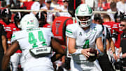 Sep 14, 2024; Lubbock, Texas, USA;  North Texas Mean Green quarterback Chandler Morris (4) prepares to give the ball to running back Damashja Harris (44) in the first half at Jones AT&T Stadium and Cody Campbell Field. Mandatory Credit: Michael C. Johnson-Imagn Images
