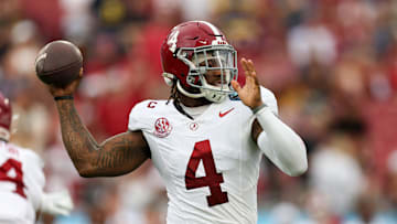 Dec 31, 2024; Tampa, FL, USA; Alabama Crimson Tide quarterback Jalen Milroe (4) drops back to pass against the Michigan Wolverines in the first quarter  during the ReliaQuest Bowl at Raymond James Stadium. Mandatory Credit: Nathan Ray Seebeck-Imagn Images