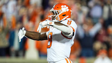 Clemson Tigers running back Adam Randall (8) throws down Ls after scoring a Tiger touchdown to take the lead over Louisville in the first half at L&N Stadium Friday, Nov. 14, 2025.