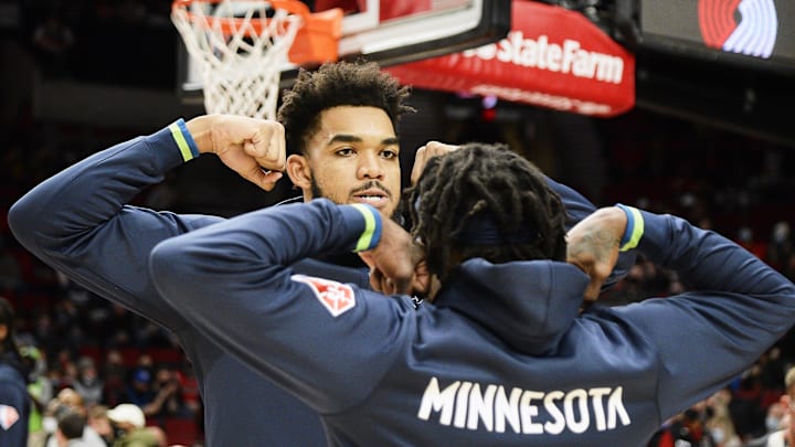 Dec 12, 2021; Portland, Oregon, USA; Minnesota Timberwolves center Karl-Anthony Towns (32) poses with guard Patrick Beverley (22) before a game against the Portland Trail Blazers at Moda Center. The Minnesota Timberwolves won 116-111. Mandatory Credit: Troy Wayrynen-Imagn Images