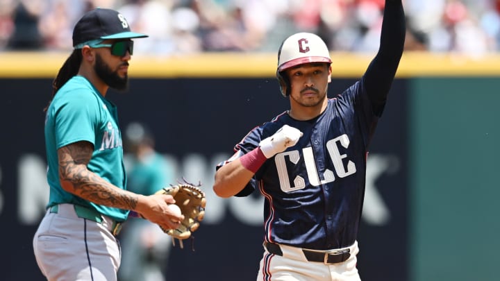 Jun 20, 2024; Cleveland, Ohio, USA; Cleveland Guardians left fielder Steven Kwan (38) celebrates after hitting a double as Seattle Mariners shortstop J.P. Crawford (3) looks on during the first inning at Progressive Field. Mandatory Credit: Ken Blaze-USA TODAY Sports