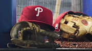 Aug 16, 2023; Toronto, Ontario, CAN; A Philadelphia Phillies cap and glove sit in the dugout during a game against the Toronto Blue Jays at Rogers Centre. Mandatory Credit: John E. Sokolowski-Imagn Images