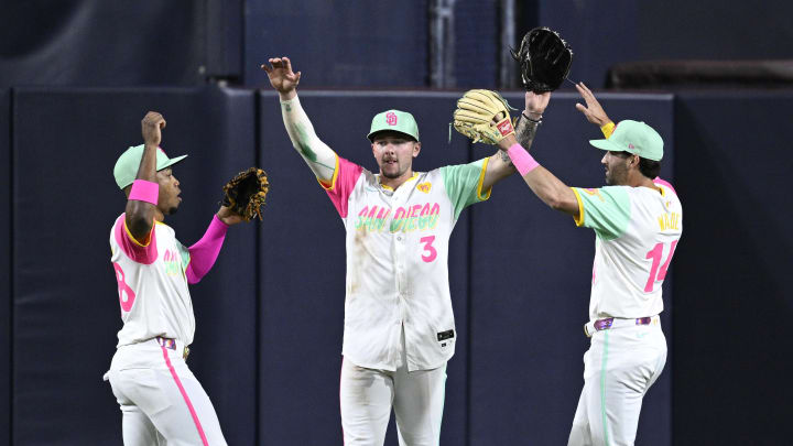 Jun 21, 2024; San Diego, California, USA; San Diego Padres center fielder Jackson Merrill (3) celebrates on the field with left fielder Jose Azocar (28) and right fielder Tyler Wade (14) after defeating the Milwaukee Brewers at Petco Park. Mandatory Credit: Orlando Ramirez-USA TODAY Sports