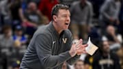 Mar 12, 2025; Nashville, TN, USA;  Vanderbilt Commodores head coach Mark Byington cheers on his team against the Texas Longhorns during the second half at Bridgestone Arena. Mandatory Credit: Steve Roberts-Imagn Images