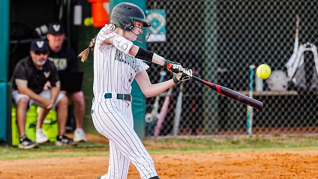 Melbourne’s Addison Balavender drives a Viera pitch into the outfield during the Class 6A, District 7 softball championship game. The freshman struck out 11 and allowed just three hits and one walk in five innings pitched, and went 1-for-2 with three RBI to power the Bulldogs past Viera, 11-0.