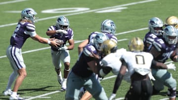 Kansas State Wildcats quarterback Avery Johnson (2) hands the ball to Kansas State Wildcats running back Dylan Edwards.