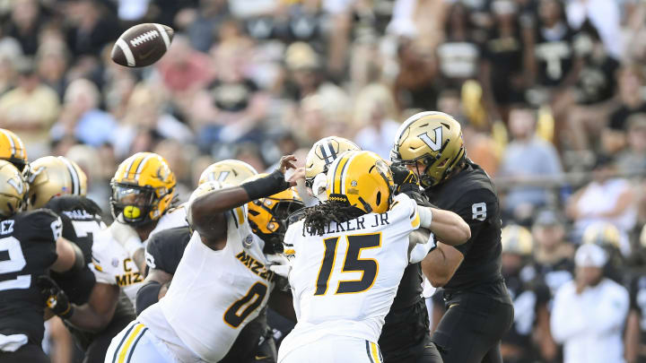 Sep 30, 2023; Nashville, Tennessee, USA; Vanderbilt Commodores quarterback Ken Seals (8) throws a wobbly pass after being hit by Missouri Tigers defensive lineman Jayden Jernigan (0) and defensive lineman Johnny Walker Jr. (15) during the second half at FirstBank Stadium.