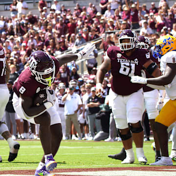 Sep 7, 2024; College Station, Texas, USA; Texas A&M Aggies running back Le'Veon Moss (8) scores a touchdown against the McNeese State Cowboys during the first quarter at Kyle Field.