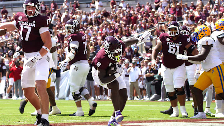 Sep 7, 2024; College Station, Texas, USA; Texas A&M Aggies running back Le'Veon Moss (8) scores a touchdown against the McNeese State Cowboys during the first quarter at Kyle Field.