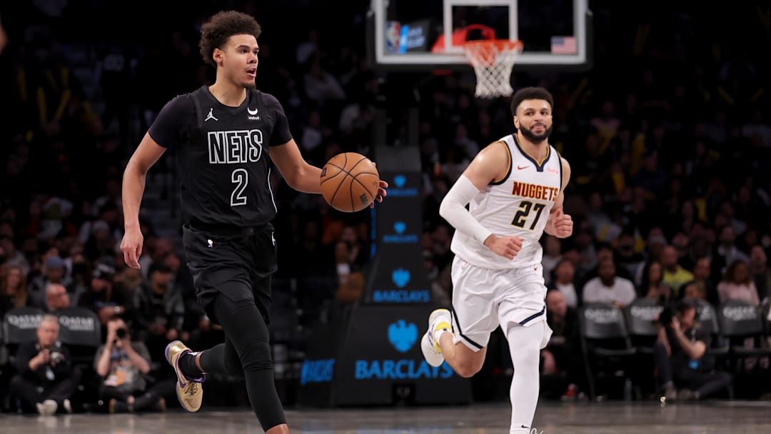 Dec 22, 2023; Brooklyn, New York, USA; Brooklyn Nets forward Cameron Johnson (2) brings the ball up court against against Denver Nuggets guard Jamal Murray (27) during the third quarter at Barclays Center. Mandatory Credit: Brad Penner-Imagn Images