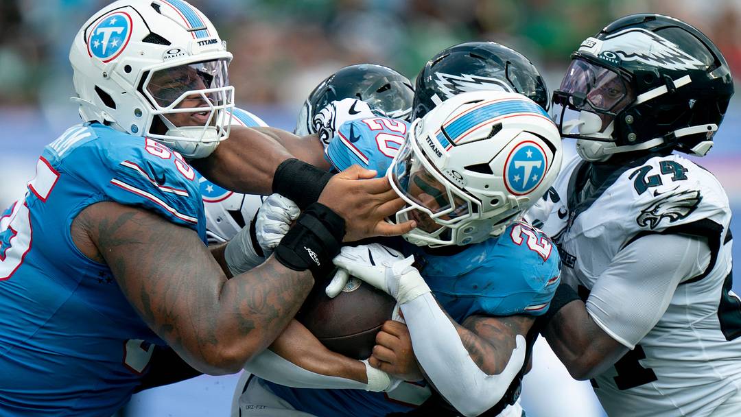 Tennessee running back Tony Pollard (20) gets tangled up with offensive tackle JC Latham (55) and Philadelphia safety Andrew Mukuba (24) on a run during the fourth quarter of their game at Nissan Stadium Sunday, Sept. 20, 2026.