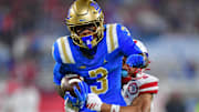 Nov 8, 2025; Pasadena, California, USA; UCLA Bruins wide receiver Kwazi Gilmer (3) runs the ball ahead of Nebraska Cornhuskers defensive back Donovan Jones (37) during the first half at the Rose Bowl. Mandatory Credit: Gary A. Vasquez-Imagn Images