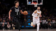 Dec 22, 2023; Brooklyn, New York, USA; Brooklyn Nets forward Cameron Johnson (2) brings the ball up court against against Denver Nuggets guard Jamal Murray (27) during the third quarter at Barclays Center. Mandatory Credit: Brad Penner-Imagn Images