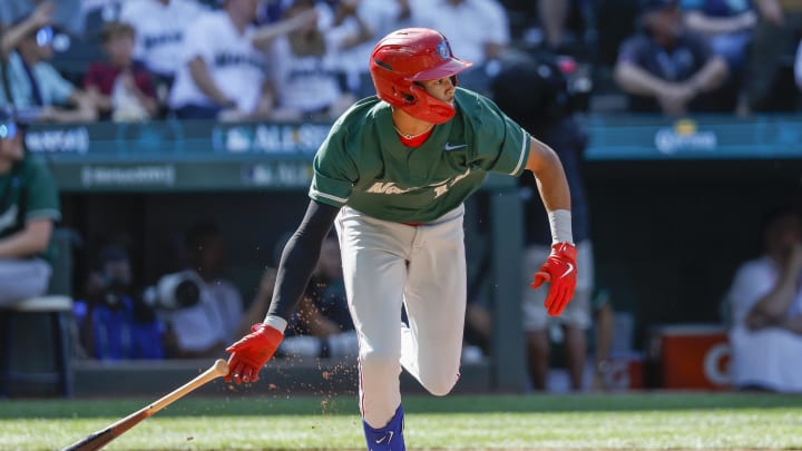 Jul 8, 2023; Seattle, Washington, USA; National League Futures designated hitter Justin Crawford (13) of the Philadelphia Phillies hits an RBI-sacrifice fly against the American League Futures during the second inning of the All Star-Futures Game at T-Mobile Park.