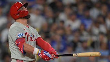 Sep 17, 2025; Los Angeles, California, USA;  Philadelphia Phillies left fielder Kyle Schwarber (12) flies out in the sixth inning against the Los Angeles Dodgers at Dodger Stadium. Mandatory Credit: Jayne Kamin-Oncea-Imagn Images