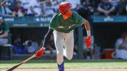 Jul 8, 2023; Seattle, Washington, USA; National League Futures designated hitter Justin Crawford (13) of the Philadelphia Phillies hits an RBI-sacrifice fly against the American League Futures during the second inning of the All Star-Futures Game at T-Mobile Park. 