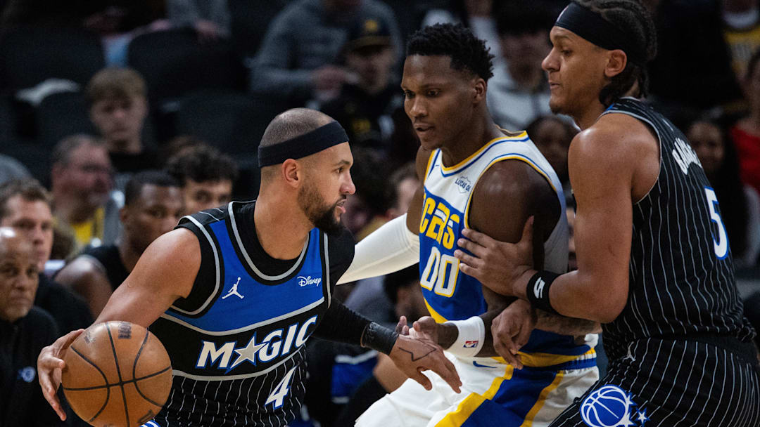 Dec 31, 2025; Indianapolis, Indiana, USA;  Orlando Magic guard Jalen Suggs (4) dribbles the ball while Indiana Pacers guard/forward Bennedict Mathurin (00) defends in the first half at Gainbridge Fieldhouse. Mandatory Credit: Trevor Ruszkowski-Imagn Images