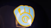 Jun 18, 2023; Milwaukee, Wisconsin, USA;  A Milwaukee Brewers logo on a batting helmet in the dugout prior to the game against the Pittsburgh Pirates at American Family Field. Mandatory Credit: Jeff Hanisch-Imagn Images