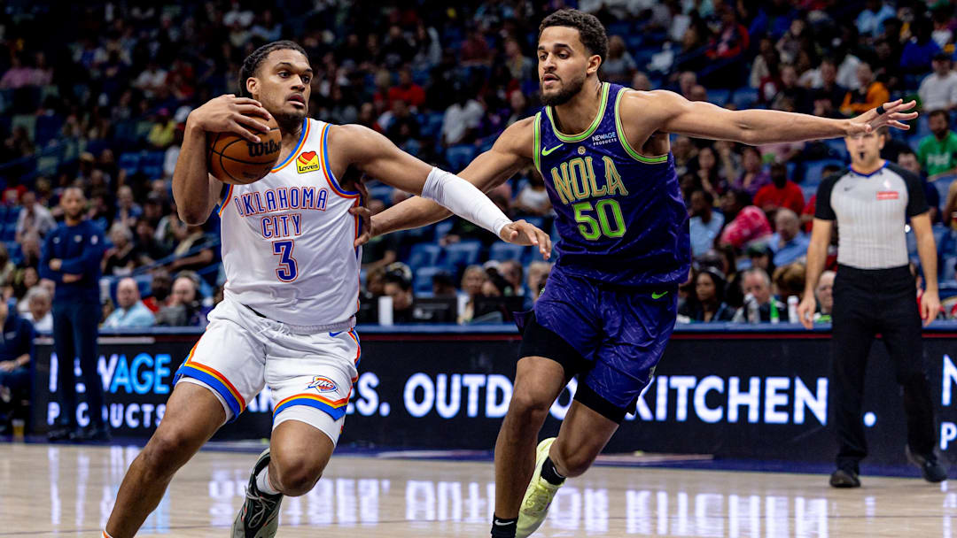 Apr 13, 2025; New Orleans, Louisiana, USA;  Oklahoma City Thunder forward Dillon Jones (3) dribbles against New Orleans Pelicans forward Jeremiah Robinson-Earl (50) during the first half at Smoothie King Center. Mandatory Credit: Stephen Lew-Imagn Images