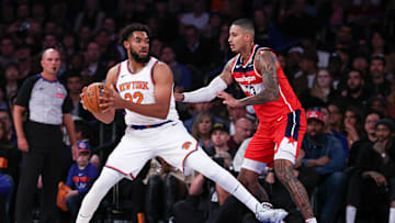 Oct 9, 2024; New York, New York, USA; New York Knicks center Karl-Anthony Towns (32) is defended by Washington Wizards forward Kyle Kuzma (33) during the first quarter at Madison Square Garden. Mandatory Credit: Vincent Carchietta-Imagn Images