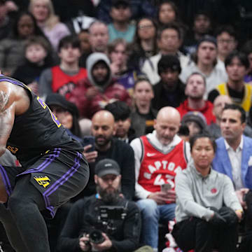 Apr 2, 2024; Toronto, Ontario, CAN; Los Angeles Lakers forward LeBron James (23) controls the ball as Toronto Raptors forward Bruce Brown (11) tries to defend during the third quarter at Scotiabank Arena. Mandatory Credit: Nick Turchiaro-Imagn Images