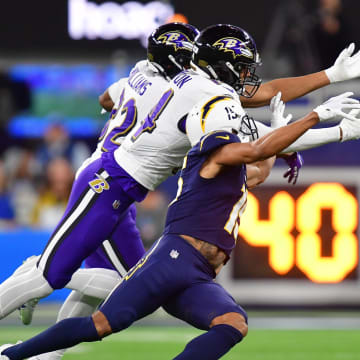 Nov 26, 2023; Inglewood, California, USA; Baltimore Ravens safety Kyle Hamilton (14) and safety Marcus Williams (32) block a pass intended for Los Angeles Chargers wide receiver Jalen Guyton (15) during the first half at SoFi Stadium. Mandatory Credit: Gary A. Vasquez-USA TODAY Sports