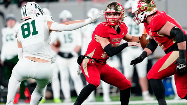 Dominic Campanile looks to pass to a Bergen Catholic teammate as Connor Martin, of Delbarton, plays defense